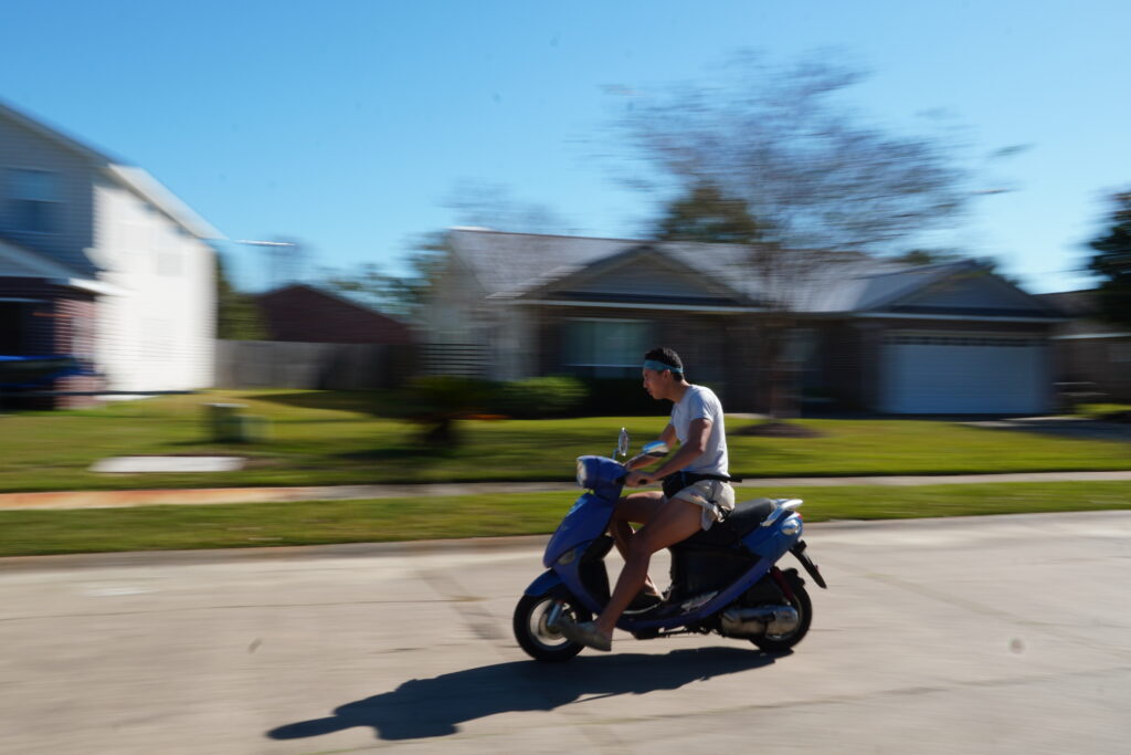 Blurred background, moving on a moped